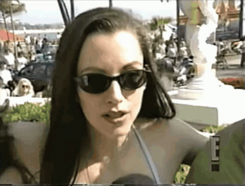 Woman With Sunglasses Talking Into Microphone 'E