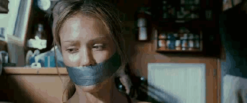 Woman With Tape On Mouth Talking On Phone GIF