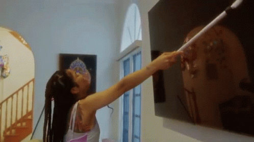 Woman With Tattoo Pointing At Wall GIF