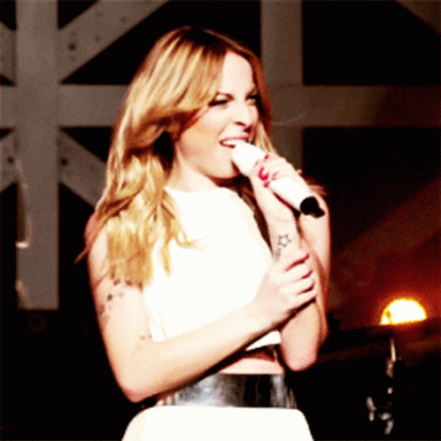 Woman With Tattoo Singing Into Microphone