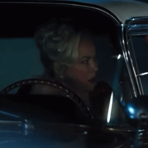 Woman With Tiara Driving Car at Night