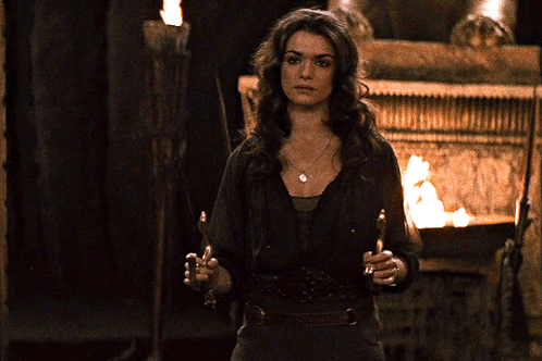 Woman With Torch In Front Of Fire