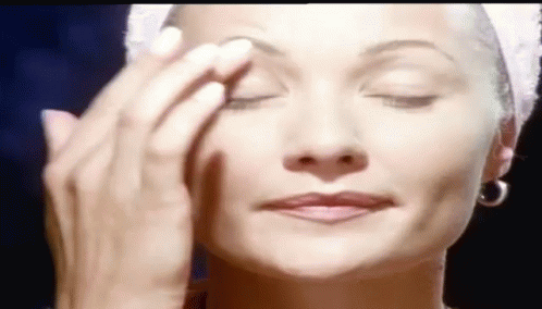 Woman With Towel On Head Applying Makeup GIF