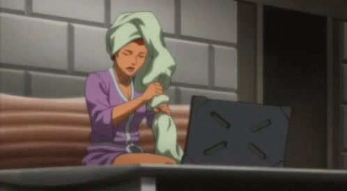Woman With Towel On Head Sits At Laptop GIF