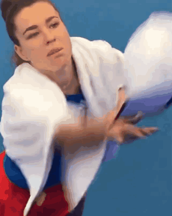 Woman With Towel Throwing Tennis Ball