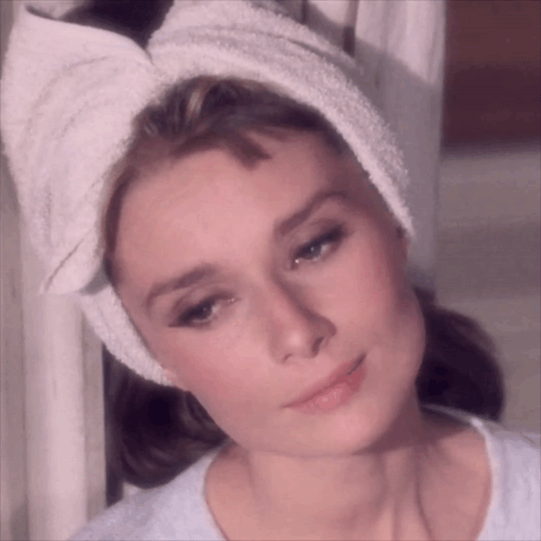 Woman With Towel Wrapped Around Head Looks at Camera