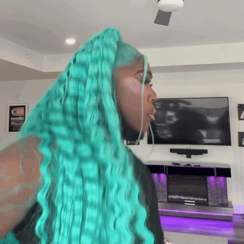 Woman With Turquoise Hair in Front of Television