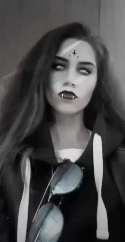 Woman With Vampire Makeup and Sunglasses