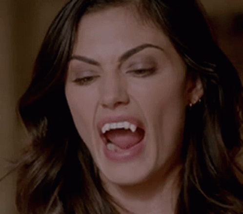 Woman With Vampire Teeth Making Funny Face GIF