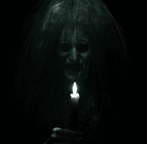 Woman With Veil Holding Lit Candle GIF