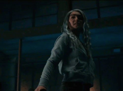 Woman With White Hair Standing Eyes Closed In Dark Room GIF