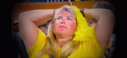 Woman With Yellow Pom Poms Watching Game