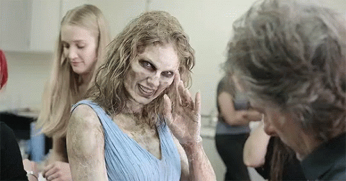 Woman With Zombie Makeup Talking To Man GIF