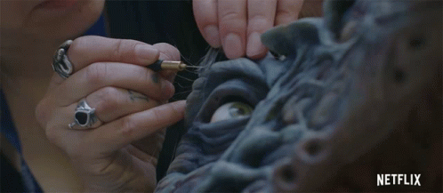 Woman Working on Statue with Netflix Logo