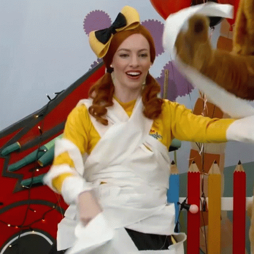 Woman Wrapped in Toilet Paper Wearing Yellow Shirt Saying Wiggle