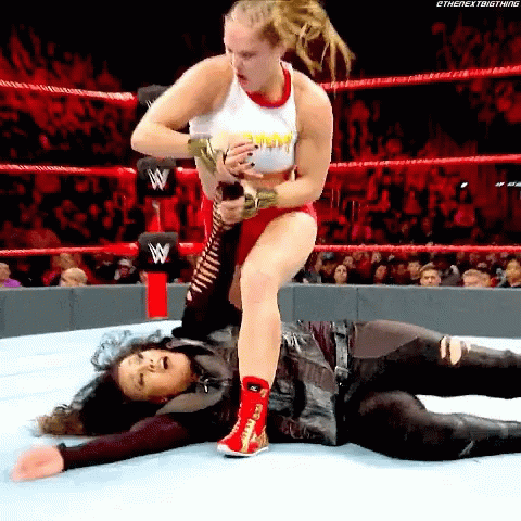 Woman Wrestling Woman with Microphone