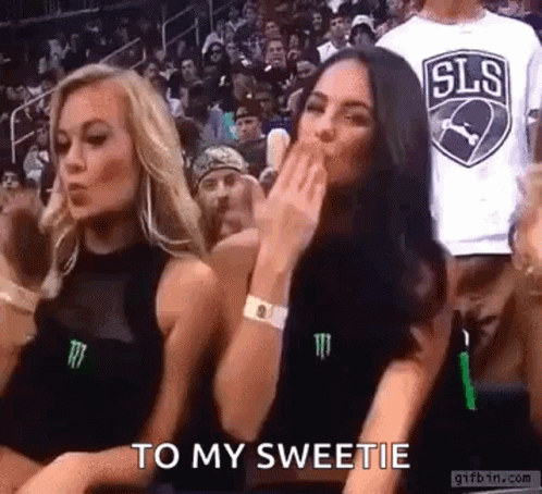 Women Blowing Kisses at Basketball Game