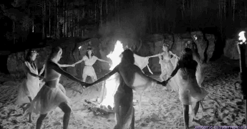 Women Dancing Around Fire On Beach GIF