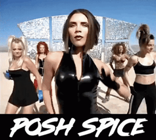 Women Dancing at Posh Spice Sign