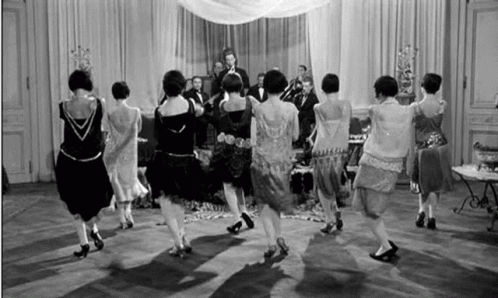 Women Dancing in Circle in Front of Band