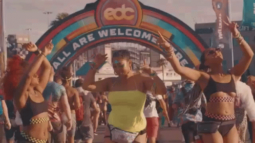 Women Dancing in Front of EDC All Are Welcome Sign