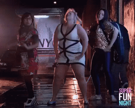 Women Dancing on Wet Sidewalk in Dark Alley
