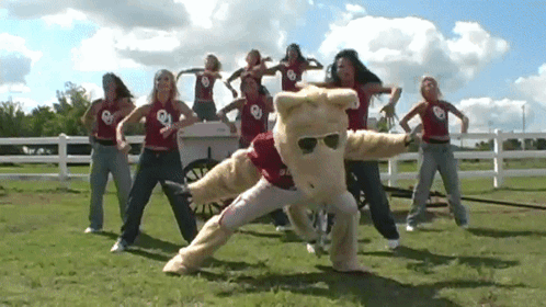 Women Dancing With Mascot Saying Oklahoma GIF