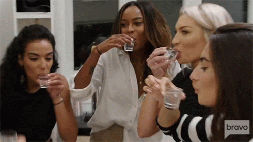 Women Drinking Shot Glasses With Bravo Logo