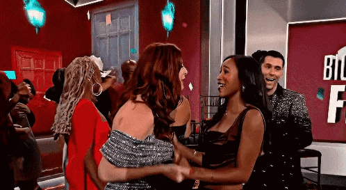 Women Hugging With Man Looking On GIF