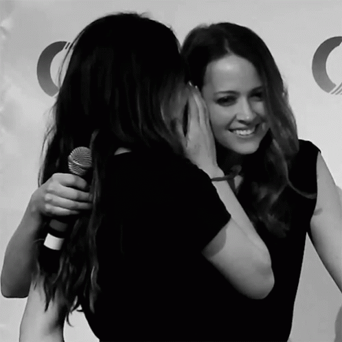 Women Hugging With Microphone
