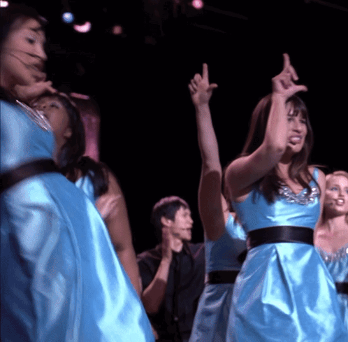 Women in Blue Satin Dresses Dancing on Stage