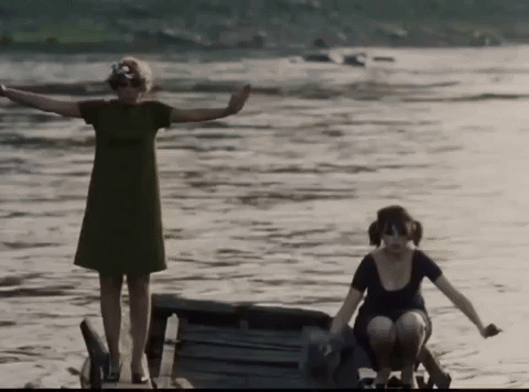 Women In Green And Black Dresses Standing In Water GIF