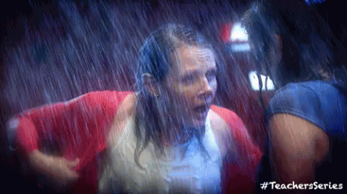 Women In Red Jackets Standing In Rain GIF