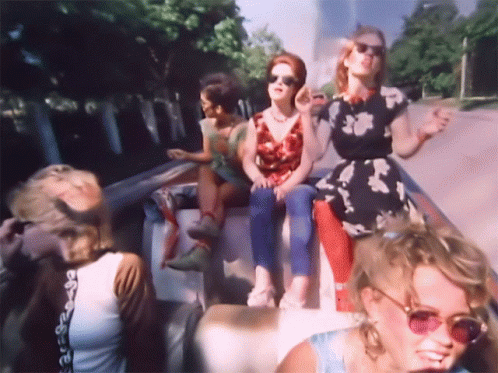 Women in Sunglasses on Back of Truck