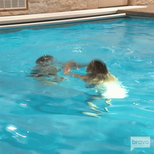 Women Jumping Into Pool with Bravo Logo