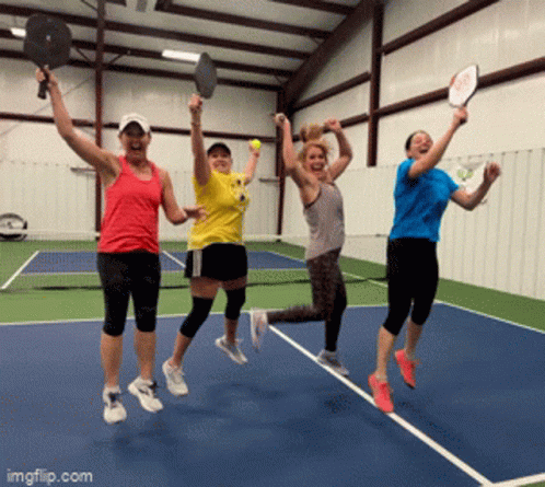 Women Jumping With Tennis Rackets