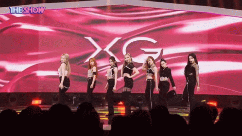 Women on Stage With XG Screen