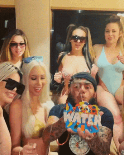 Women Posing With Man Holding Water Bag