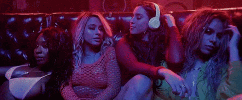 Women Sitting on Couch in Dark Room
