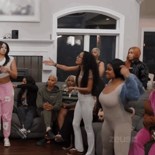Women Sitting On Couch With Zeus GIF