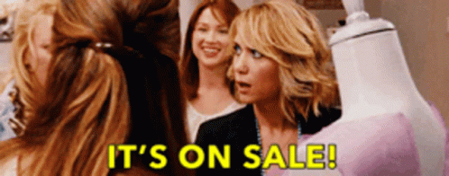Women Standing Around Mannequin Saying It's On Sale GIF