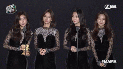 Women Standing in Front of Mnet Sign