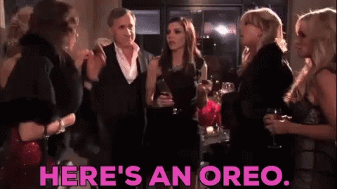 Women Standing In Room With Oreo GIF