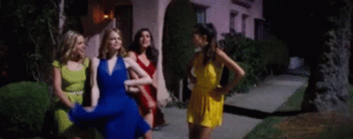 Women Standing On Sidewalk In Front Of House GIF