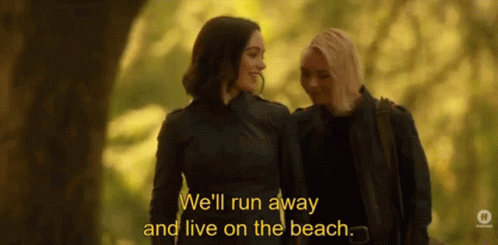 Women Walking In Woods Discussing Living On Beach GIF