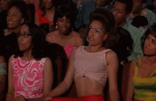 Women Watching Movie In Theater, One In Crop Top GIF