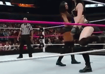 Women Wrestling in Ring with Referee