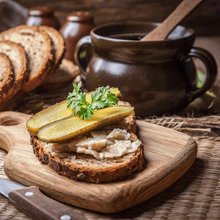 Wooden Cutting Board With Sandwich And Pickles GIF