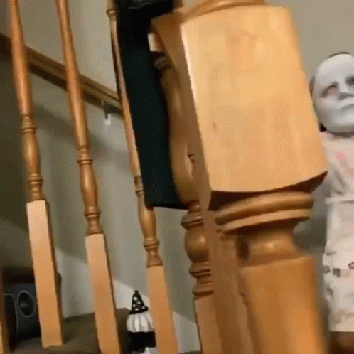 Wooden Railing Next To Statue Of Man GIF