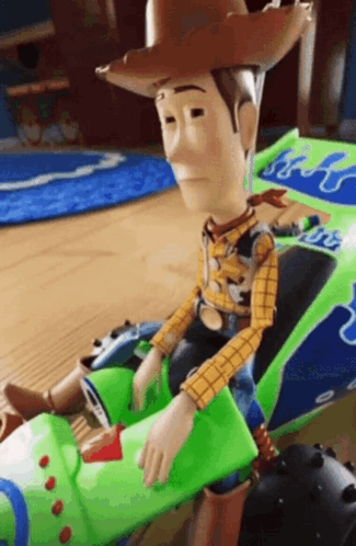 Woody Sitting on Green Toy Car